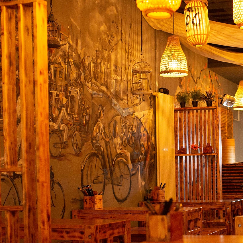 Wandmalerei (mit vielen Fahrrädern und buntem Trubel) und Interieur aus Birkenholz im LÙC, einem vietnamesischen, auf vegane Speisen spezialisiertem Restaurant in der Bahnhofstraße Mainz